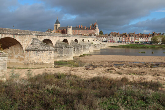 river loire and old stone bridge in gien (france)