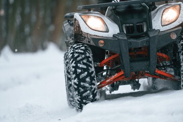 Snow, trees, adventure. Man is riding ATV outdoors in the winter forest