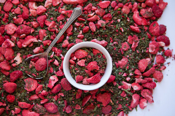 dried tea with mint and strawberries. Texture of dry herbal tea with peppermint, strawberry slices - obrazy, fototapety, plakaty