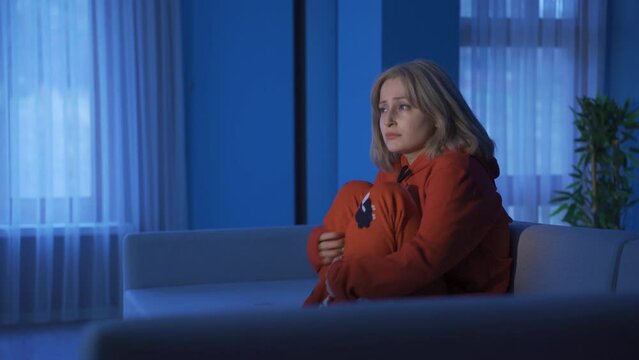 Paranoid young woman scared at home at night.
Paranoid woman gets scared when left alone at home. She has agoraphobia.
