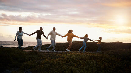 Fototapeta na wymiar Family holding hands and walking in nature for group support, growth development and adventure together in sunset. Children with grandparents for fitness, health and running by a park path or ocean