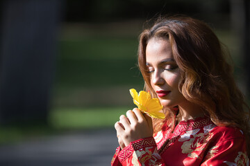 Beautiful young woman in a typical Moroccan red suit, embroidered with gold and silver threads,...