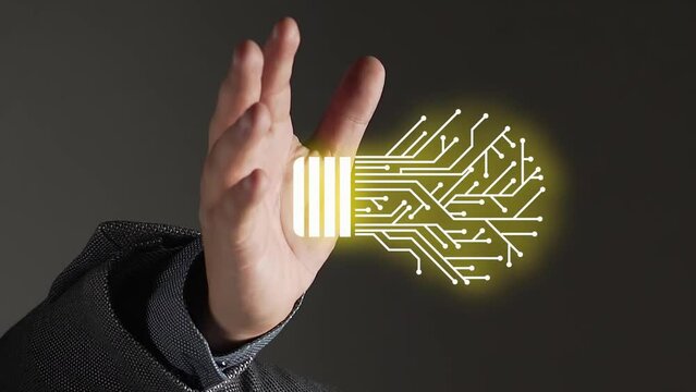 Digital light bulb with circuit board graphic illustration above outstretched caucasian hand; vertical video against dark background