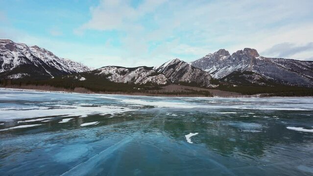 Scenery of Rocky mountains on frozen lake in Abraham Lake on winter