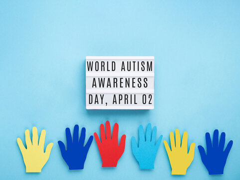 World Autism Awareness Day or month concept. Colorful Hands on Blue Background.