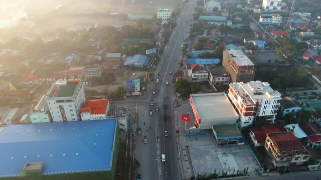 Top down panning shot of an highway intersection in Mandalay during a sunset