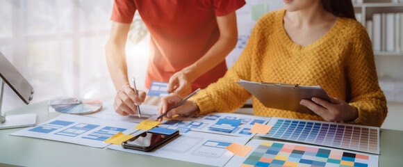 Creative digital development agency. developer team brainstorming on their project with laptop, smartphone and digital tablet.