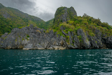 Rocky landscape with sea , mountains and trees