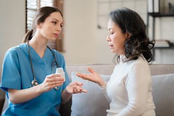 female therapist gives medication advice to an elderly patient.