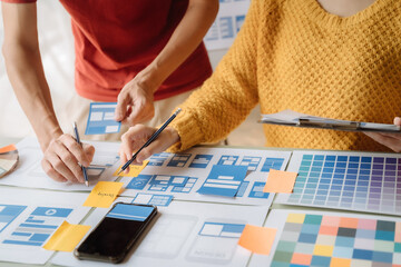 Creative digital development agency. developer team brainstorming on their project with laptop, smartphone and digital tablet.