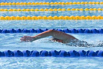 Sport man swimming in the pool at the sport complex.Professional Athlete Training for the Championship.Male Swimmer swimming in swimming pool.