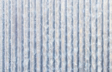 Old galvanized sheet wall with rust abstract texture background.  tough metal. cannot withstand high humidity climates. Thin galvanized steel sheet, flat or corrugated, used for roofing.