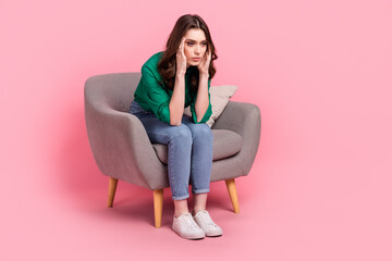 Full length photo of depressed stressed lady dressed arms temples sitting sofa isolated pink color background - obrazy, fototapety, plakaty