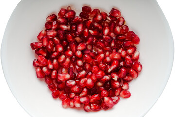 pomegranate seeds in a plate close-up top view on a transparent background