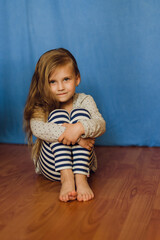 little girl sitting on the floor