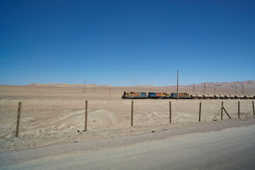 three locomotives pulling gas tank wagons through the Atacama desert.