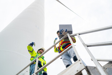 Wind turbine service engineer maintenance and plan for inspection at construction site, renewable electricity generator.