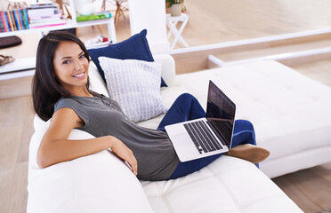 Enjoying the flexibility of freelancing. Portrait of an attractive young woman using her laptop at...