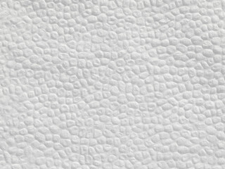 Background of textured white soft paper napkins with embossed round shape