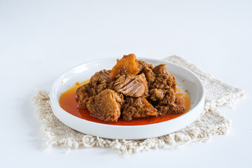 rendang is a spicy meat that slow cooked in coconut milk and mixed spices. traditional food Indonesia