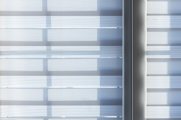 Textile translucent blinds on a window on a sunny day