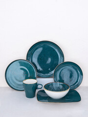 Set of empty various blue plates on table. Collection of blue dishware of different sizes on table with space for your copy