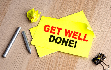 GET WELL DONE text on yellow sticky on wooden background