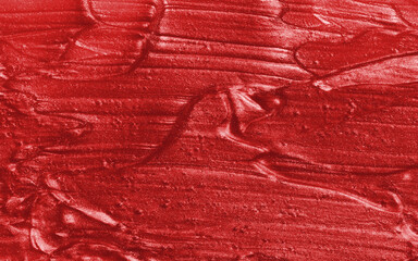 Sample of red glitter gel with small particles, texture of highlighter cosmetics, lipstick, blush