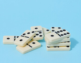 A stack of dominoes on a blue background, an intellectual game