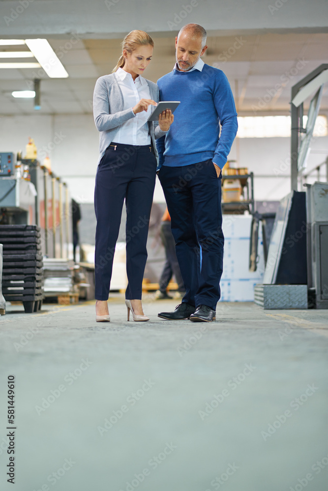 Aufkleber Looks like productivity is well above predicted. Two professional factory managers using a tablet to monitor productivity.