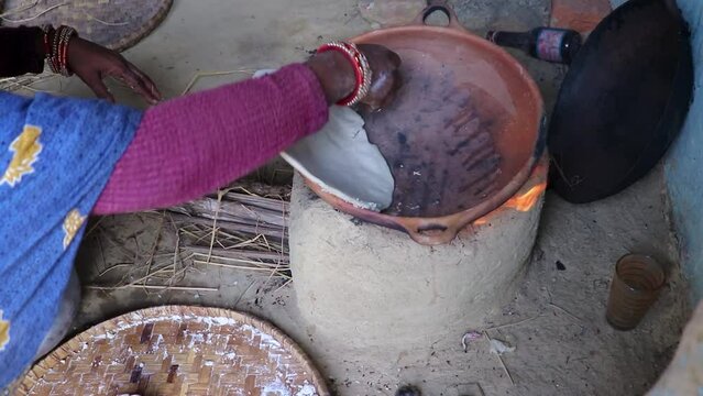 rice floor bread making in traditional soil vessels at wood fire from different angle