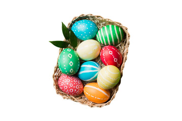 Basket of colorful Easter eggs isolated on white background. Easter basket filled with colored eggs top view holiday concept