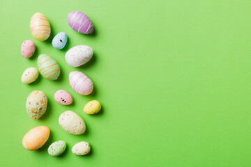 Happy Easter concept. Preparation for holiday. Easter eggs on colored background. flat lay top view copy space banner