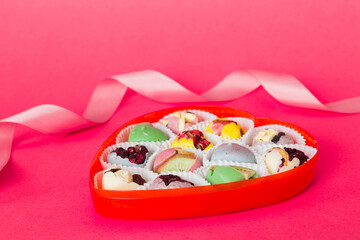Valentine day composition: sweet candy, with gift boxes with bow and red felt hearts, photo template, background. Perspective View with copy space