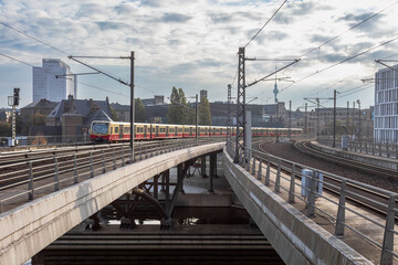 Fototapeta na wymiar S-Bahn train rolling into station on cloudy day