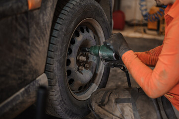 Replacement and repair of wheels and shock absorbers on a car in a garage