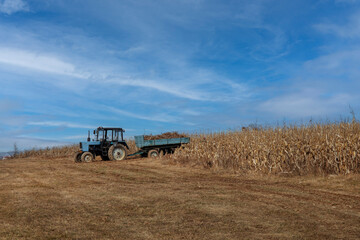 Farm tractor plowing field in a beautiful autumnal landscape.