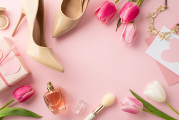 Obraz na płótnie Canvas Women's Day concept. Top view photo of giftbox tulips beige high heel shoes envelope letter necklace cosmetics brushes and perfume on isolated pastel pink background with empty space in the middle