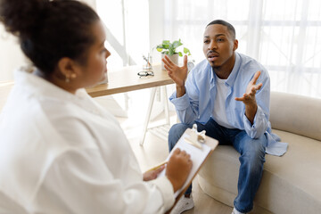 Obraz premium Anxious black man experiencing midlife crisis, have therapy session