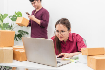 Asian man and woman checking product orders Before delivery, e-commerce, online selling and logistics Concept.