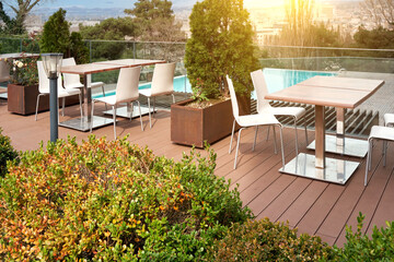 Summer cafe with tables against the backdrop of the pool.