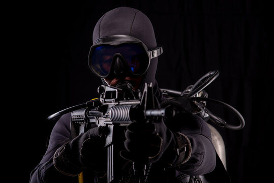 Spec ops police officer SWAT special forces  with a weapon in his hands. on a dark background. Law and order protection concept.  Poster concept for police, security or military