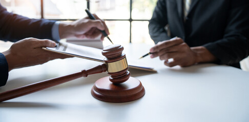 Law concept. Asian young lawyer or legal advisor explaining details Business contract agreement before signing consent to join the business in the real estate project in the office.