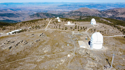Drone aerial view of Calar Alto Observatory at the snowy mountain top in Almeria, Andalusia, Spain....
