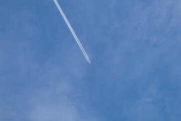 Plane in the sky.Flight from the plane.Airplane high in the sky.Flying in the sky.Blue heaven.Travel agency.White trail in the sky from the plane.Traveling by plane.Blue beautiful heaven.Flying high.