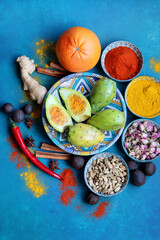 Close up photo of various spices on a table. Vivid blue background. Eating healthy concept.  