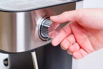 Hand Holding the Steam Knob of a Home Coffee Machine