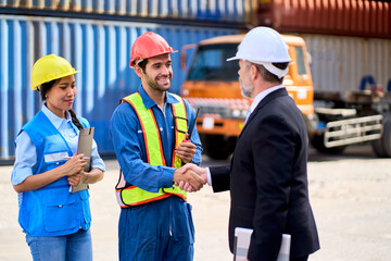 Foreman team shake hand with inspector manager in black suit for audit security and quality in container shipping site