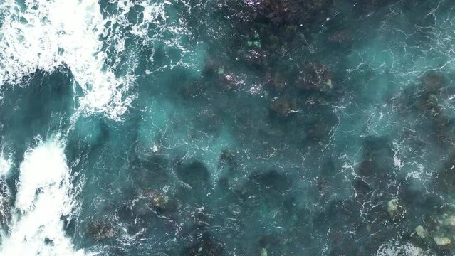 Aerial View to Ocean Waves. Blue Water Background. Top View of Foaming Blue Ocean Waters.