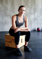 Naklejka premium Working hard to reach her fitness goals. Portrait of a fit young woman at the gym.